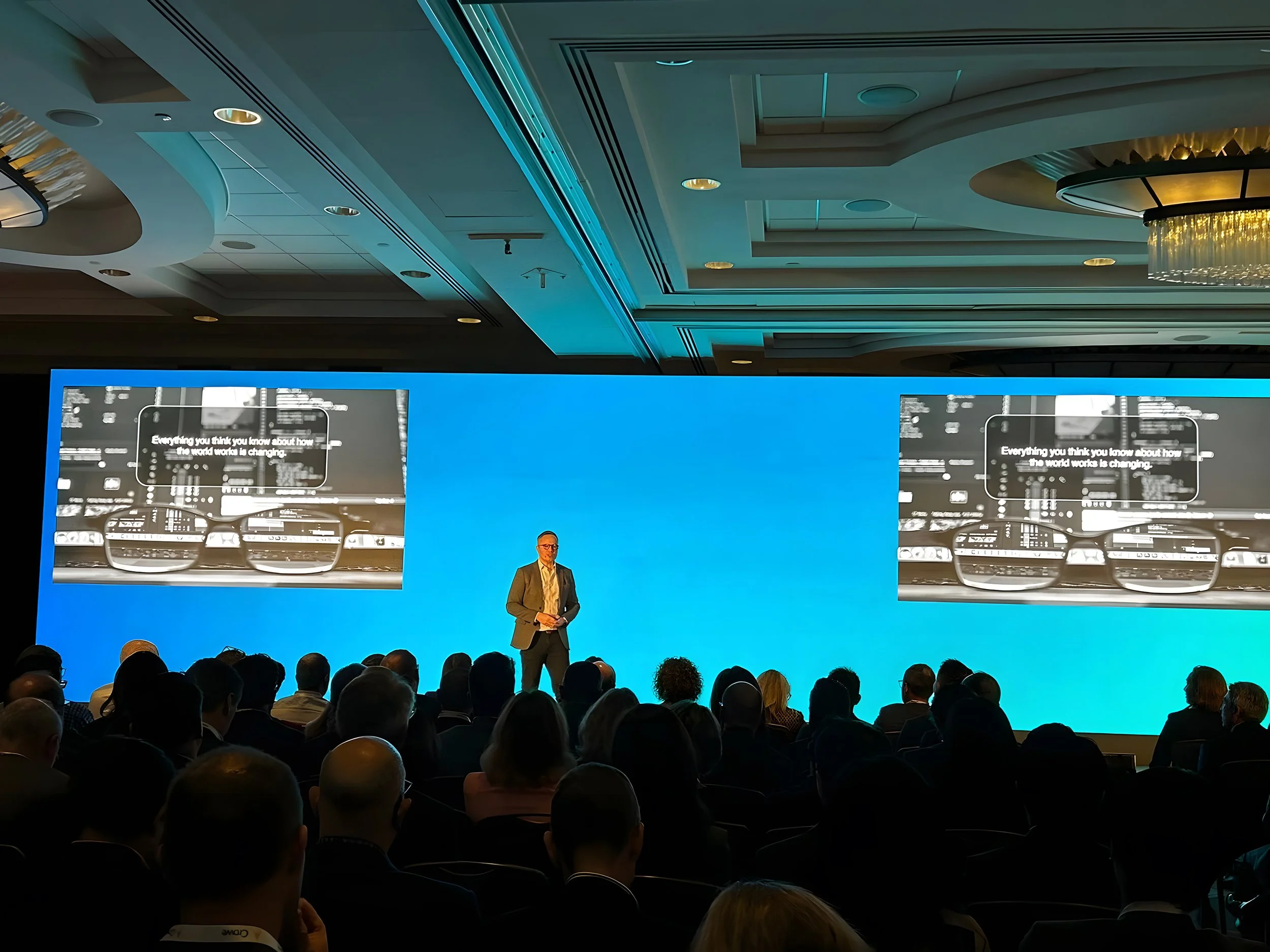 Caleb Gardner delivering a keynote on a conference stage